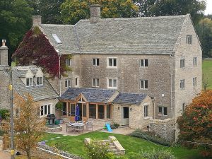 Cardinal immitation stone tile main roof and natural welsh slate lower roof